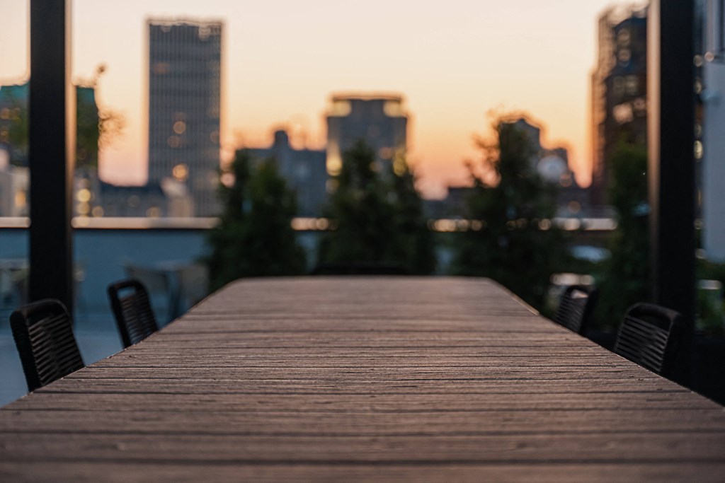 a wooden dock with a city in the background
